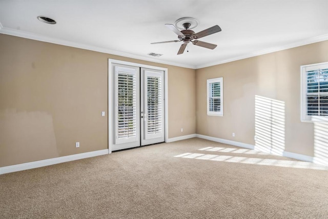 unfurnished room featuring crown molding, a ceiling fan, baseboards, and light carpet