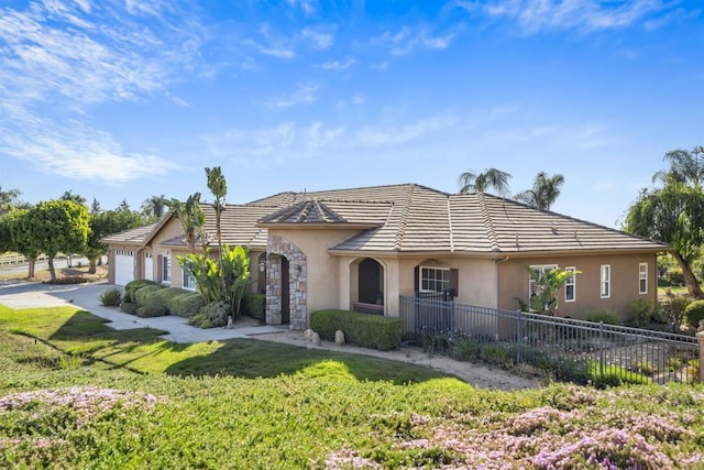 view of front of property featuring fence, an attached garage, a front lawn, stucco siding, and concrete driveway