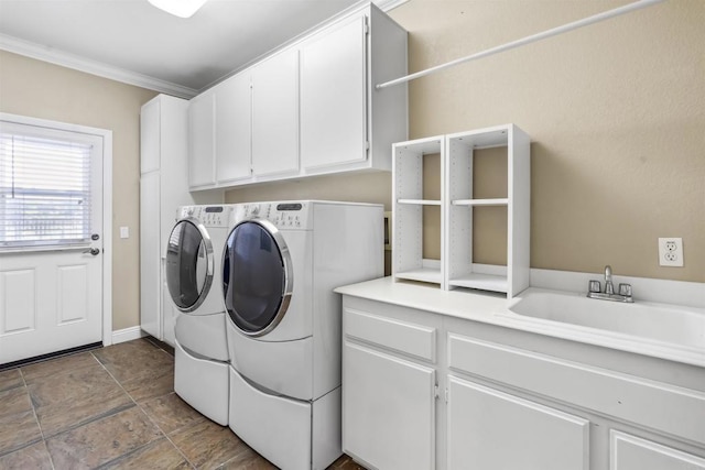 laundry room with a sink, separate washer and dryer, ornamental molding, and cabinet space