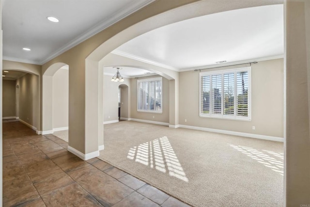 tiled spare room featuring crown molding, carpet flooring, baseboards, recessed lighting, and arched walkways