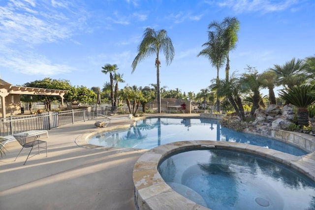 view of pool with fence, an in ground hot tub, and a fenced in pool