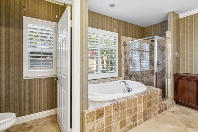 full bath with plenty of natural light, a bath, and a stall shower