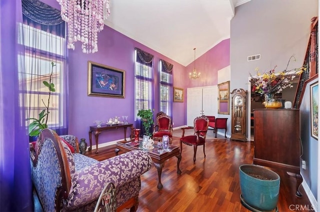 living area featuring visible vents, high vaulted ceiling, a chandelier, and a wealth of natural light