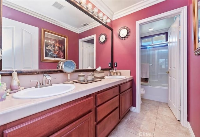 bathroom with double vanity, a sink, toilet, and ornamental molding