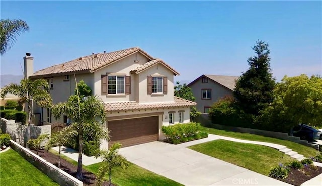 mediterranean / spanish house featuring a tiled roof, an attached garage, concrete driveway, and stucco siding