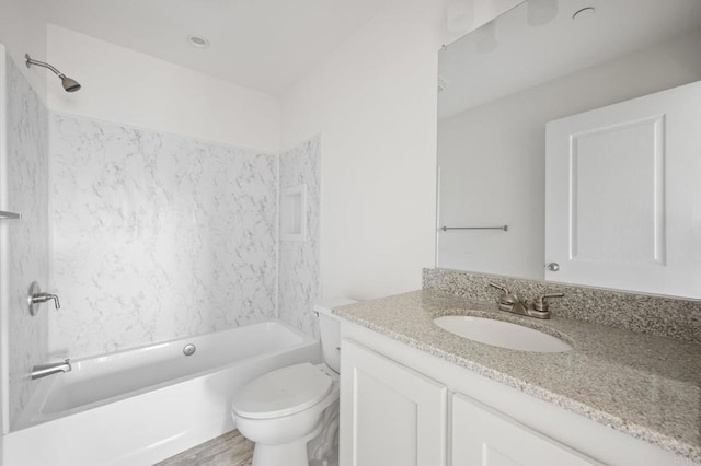 full bath featuring toilet, vanity, and  shower combination