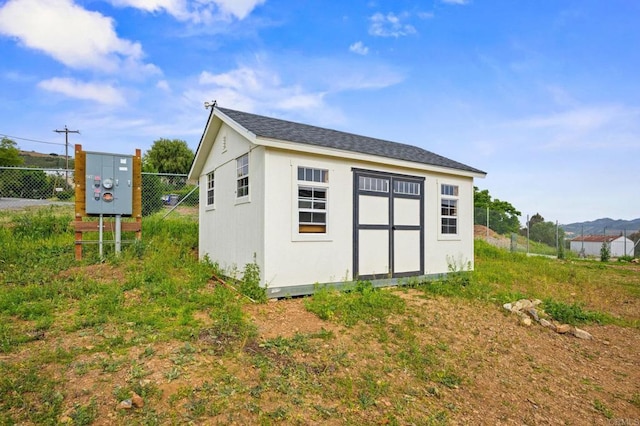 view of shed with fence