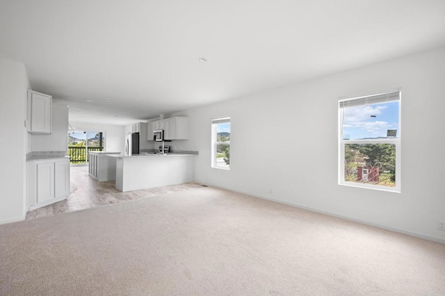 3755 Buena Creek Rd, Vista, CA 92084 - unfurnished living room with baseboards, a healthy amount of sunlight, and light carpet