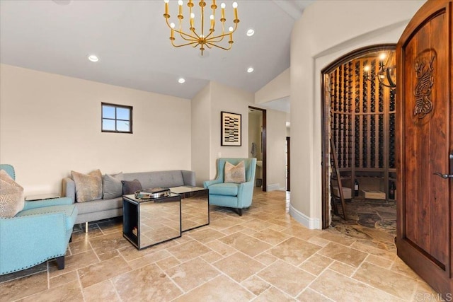 living area with stone tile floors, vaulted ceiling, recessed lighting, and a notable chandelier