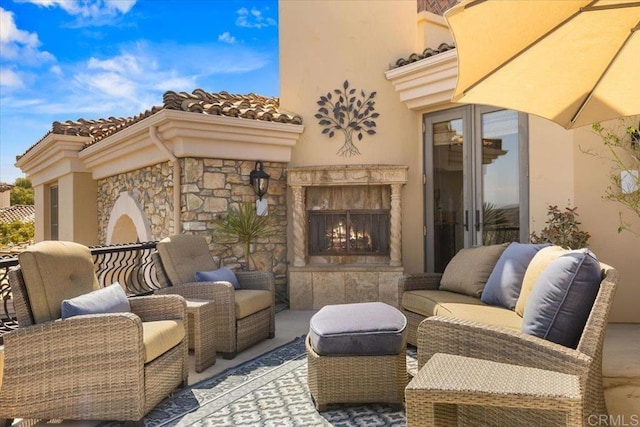 view of patio with an outdoor living space with a fireplace