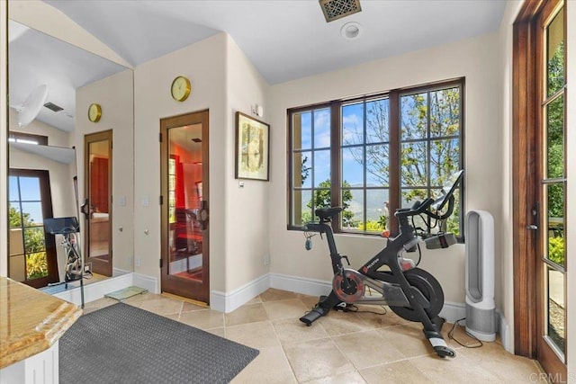 workout area featuring baseboards, a wealth of natural light, and visible vents