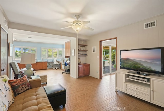 living area featuring a ceiling fan, visible vents, wood finished floors, and built in study area