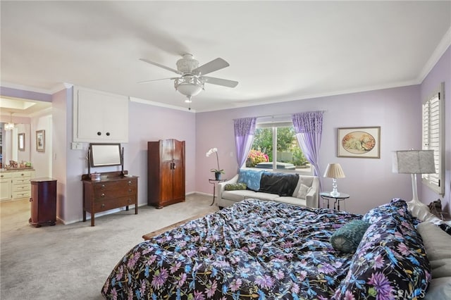 bedroom featuring crown molding, ceiling fan, light colored carpet, baseboards, and ensuite bathroom