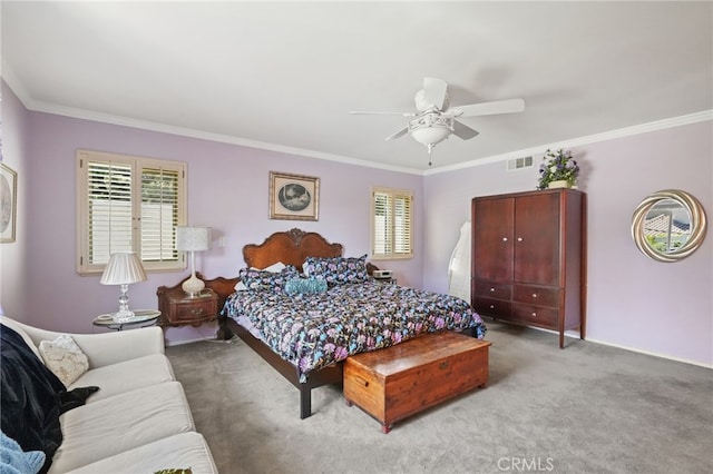 carpeted bedroom featuring crown molding, multiple windows, ceiling fan, and visible vents