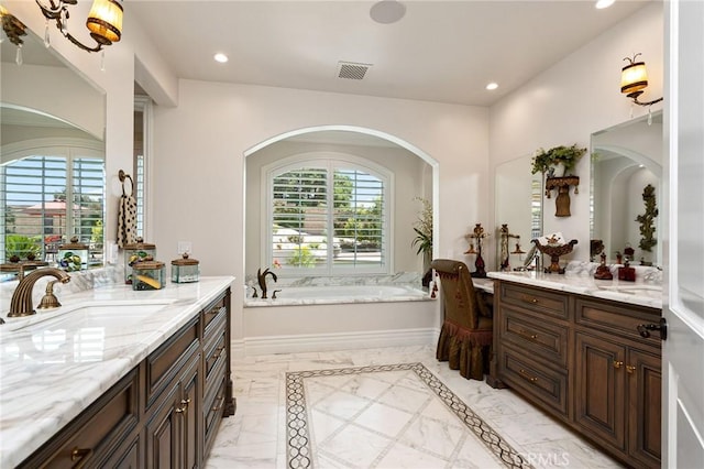 bathroom featuring two vanities, visible vents, recessed lighting, and a sink