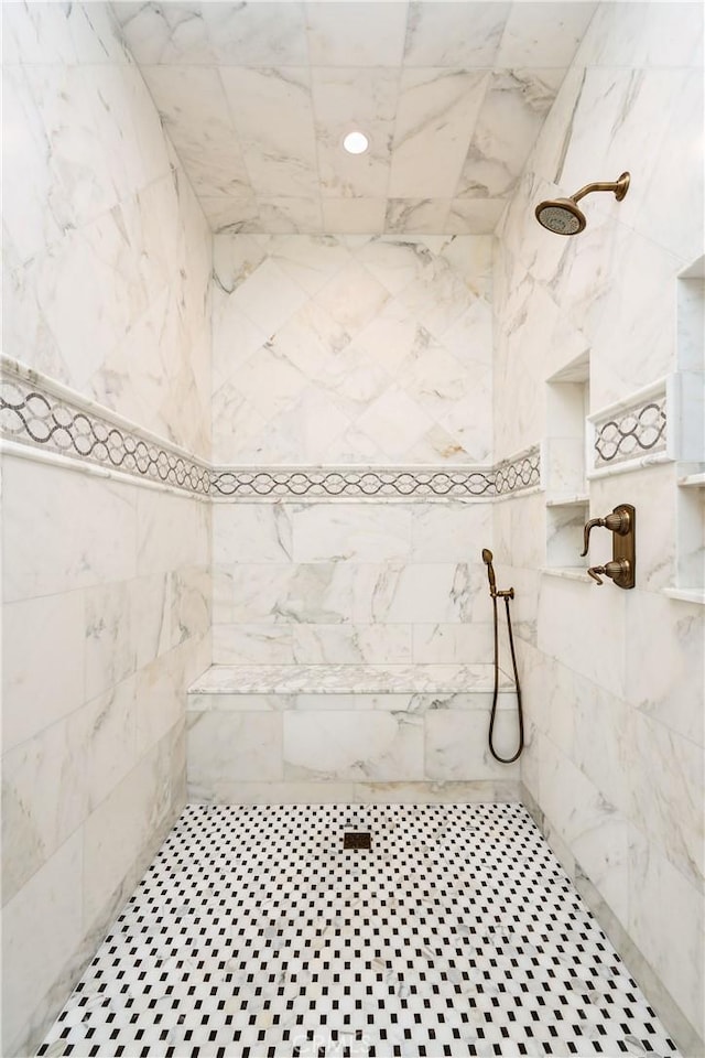 bathroom with a tile shower