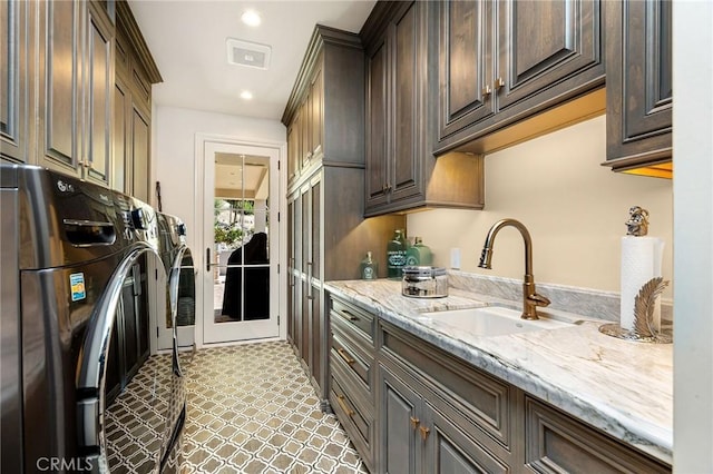 laundry room with separate washer and dryer, cabinet space, recessed lighting, and a sink