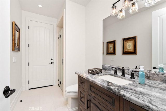 bathroom with a stall shower, baseboards, toilet, tile patterned floors, and vanity