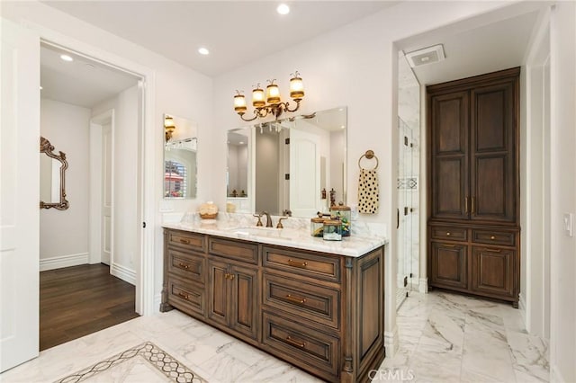 bathroom featuring recessed lighting, vanity, a chandelier, marble finish floor, and baseboards