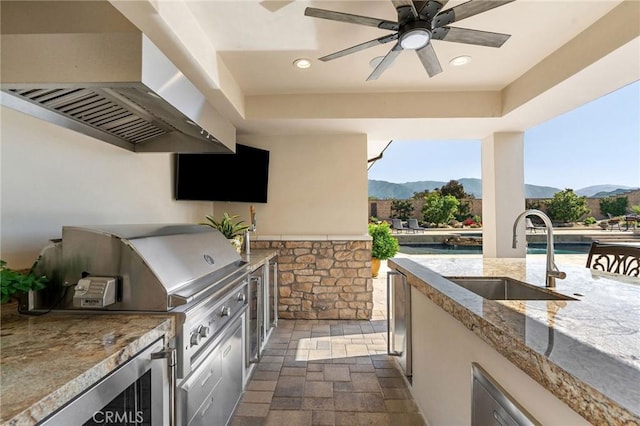 view of patio / terrace with a grill, ceiling fan, area for grilling, and a sink