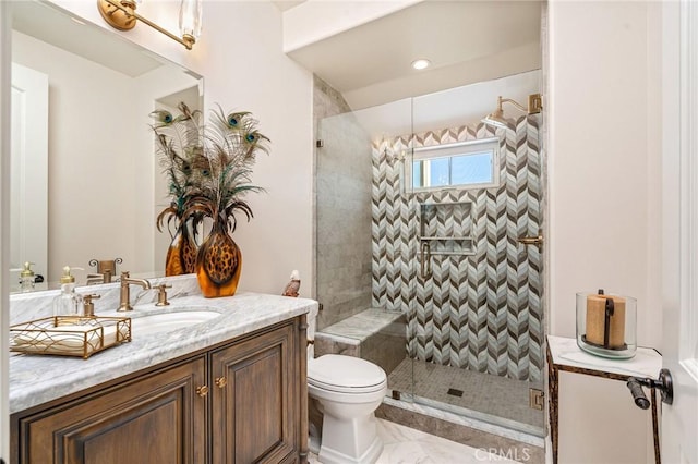 full bath featuring vanity, toilet, and a stall shower