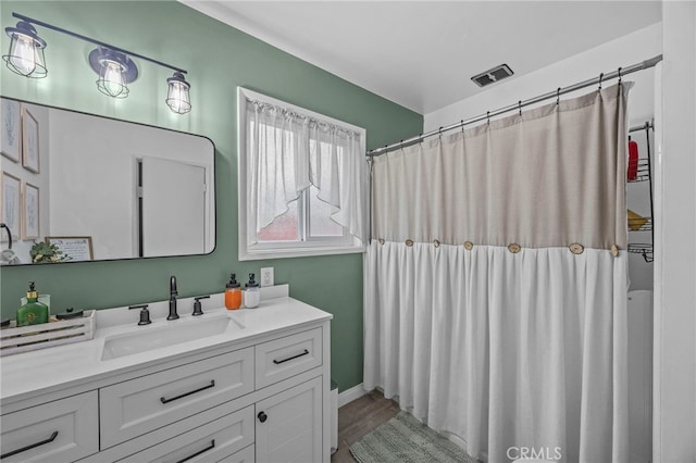 3520 Rosewood Pl, Riverside, CA 92506 - full bathroom with visible vents, wood finished floors, a shower with curtain, and vanity