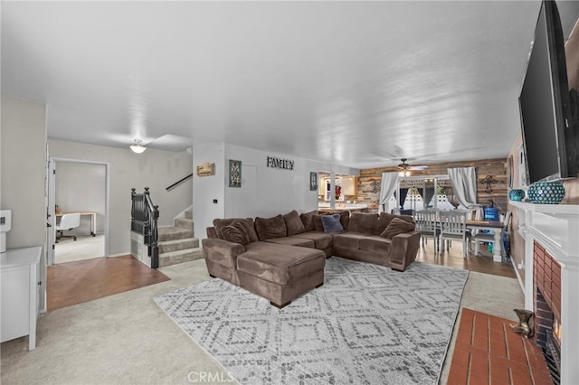 3520 Rosewood Pl, Riverside, CA 92506 - carpeted living area with a fireplace with flush hearth, a ceiling fan, and stairway