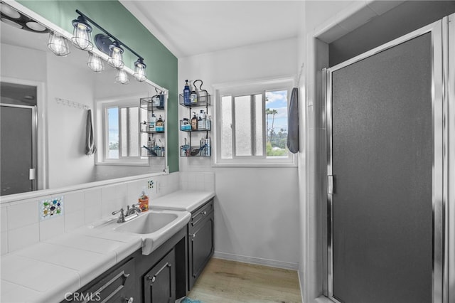 3520 Rosewood Pl, Riverside, CA 92506 - bathroom with vanity, a shower stall, and wood finished floors