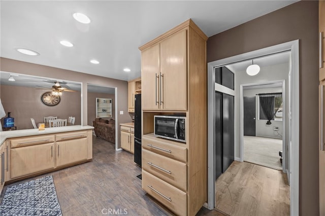 3520 Rosewood Pl, Riverside, CA 92506 - kitchen featuring dark wood-style flooring, light brown cabinetry, light countertops, stainless steel microwave, and a ceiling fan