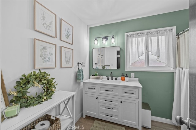 3520 Rosewood Pl, Riverside, CA 92506 - bathroom with vanity, baseboards, and wood finished floors