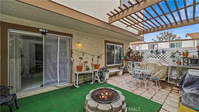 view of patio / terrace with a grill, an outdoor fire pit, and a pergola
