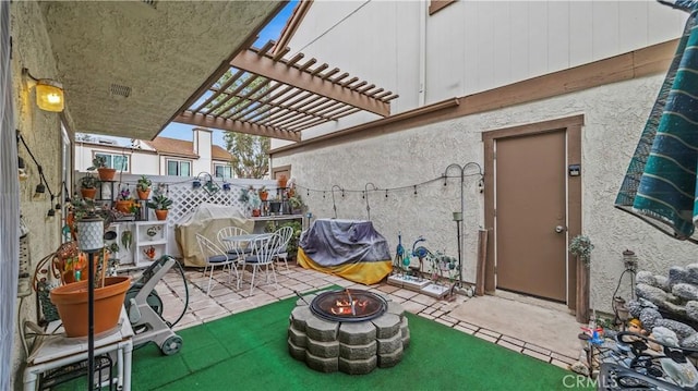 view of patio with an outdoor fire pit and a pergola