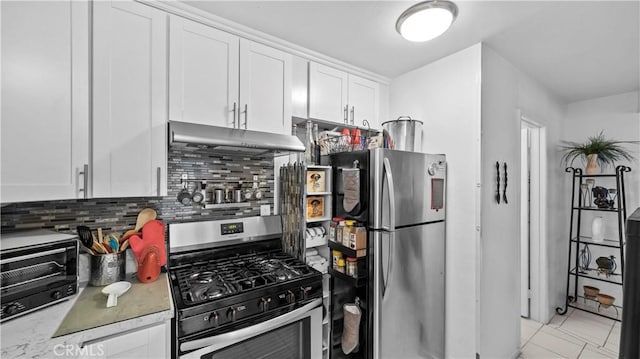 kitchen with decorative backsplash, a toaster, stainless steel appliances, under cabinet range hood, and white cabinets