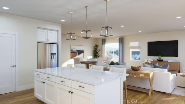 kitchen featuring recessed lighting, wood finished floors, open floor plan, and high quality fridge