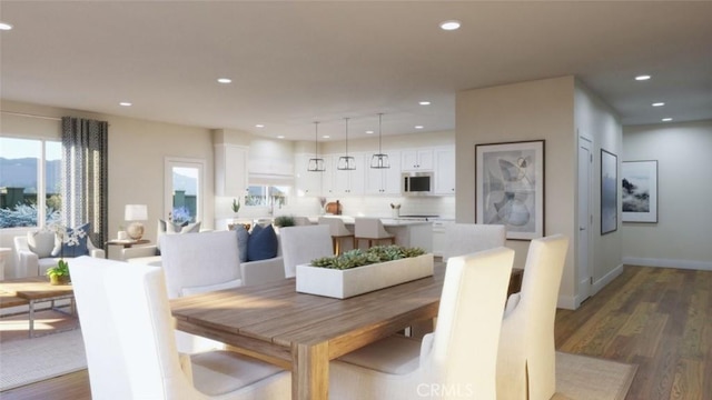 dining room with recessed lighting, wood finished floors, and baseboards