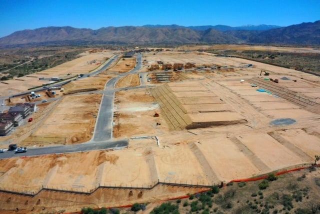birds eye view of property with view of desert, a mountain view, and a rural view