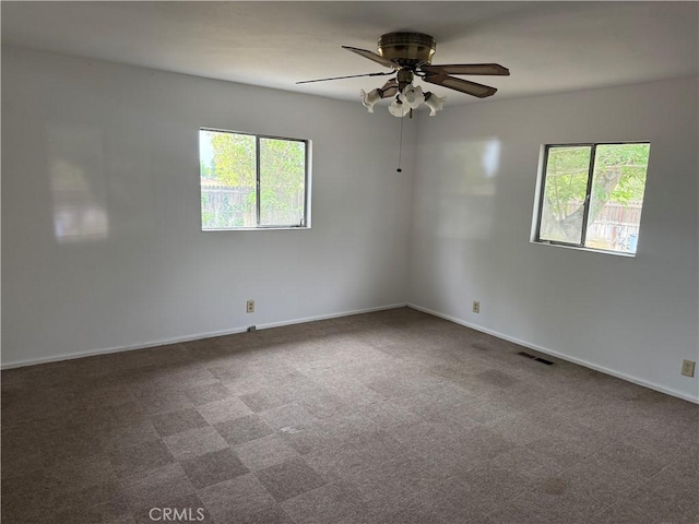 14685 17th Ave, Lemoore, CA 93245 - spare room featuring visible vents, carpet flooring, baseboards, and a ceiling fan