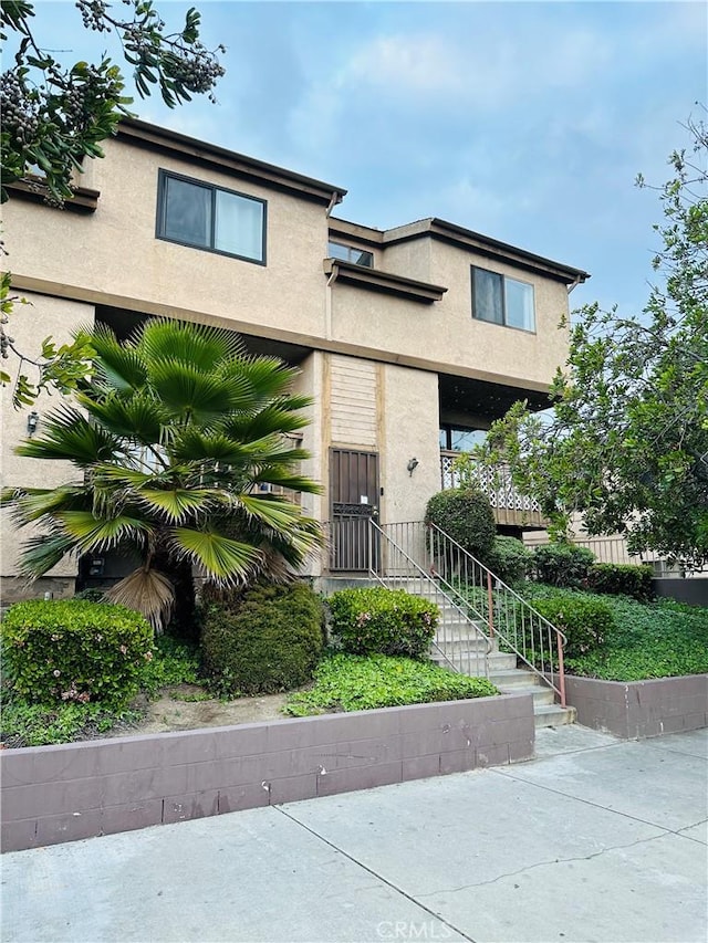 view of front of house featuring stucco siding