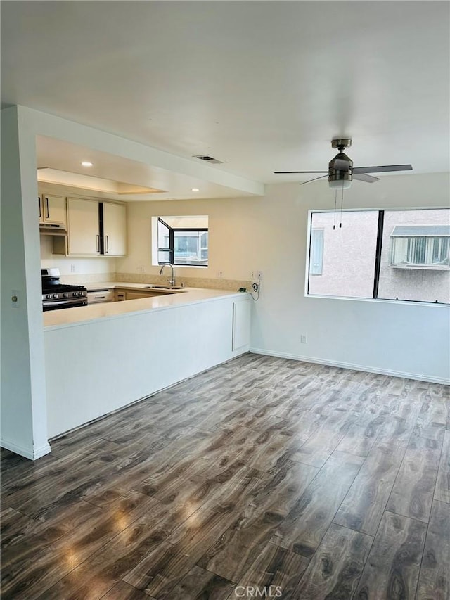 850W 157th Unit 6, Gardena, CA 90247 - kitchen featuring a ceiling fan, a sink, light countertops, stainless steel gas range, and dark wood-style floors