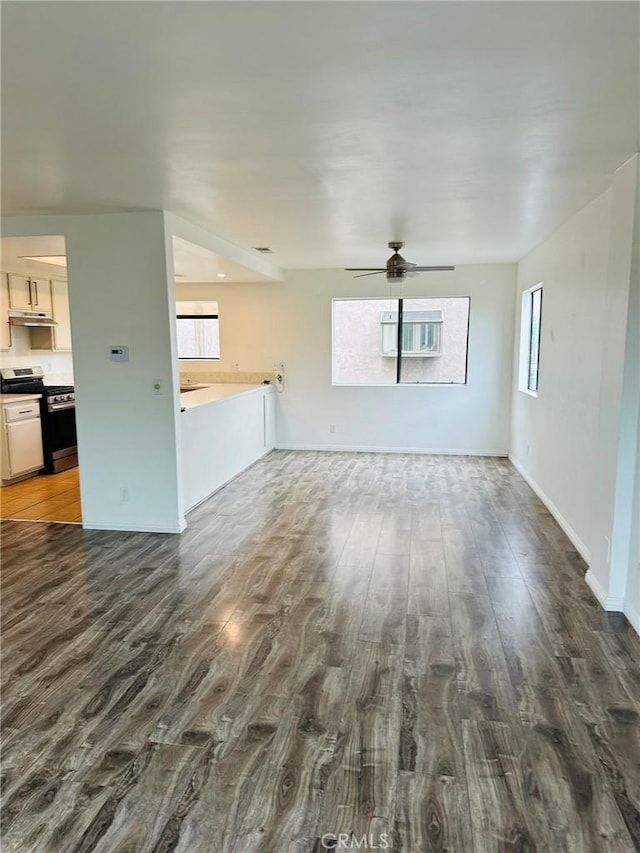 850W 157th Unit 6, Gardena, CA 90247 - unfurnished living room featuring baseboards, a ceiling fan, and dark wood-type flooring