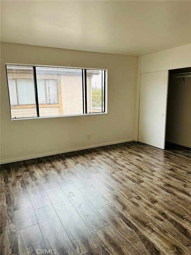 850W 157th Unit 6, Gardena, CA 90247 - unfurnished bedroom with baseboards, dark wood-style floors, and a closet
