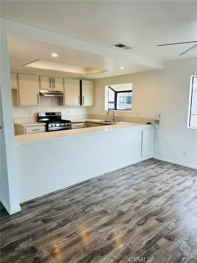 850W 157th Unit 6, Gardena, CA 90247 - kitchen with stainless steel range with gas cooktop, under cabinet range hood, dark wood-style floors, and visible vents