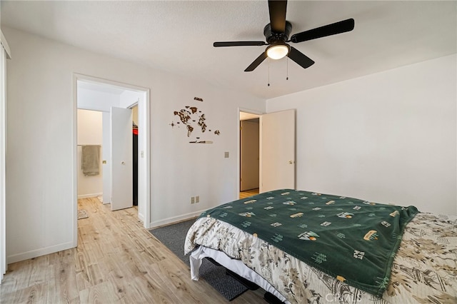 bedroom featuring ceiling fan, baseboards, and light wood-style floors