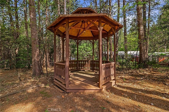 surrounding community featuring a gazebo and a wooden deck