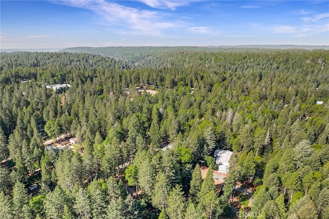 drone / aerial view featuring a wooded view