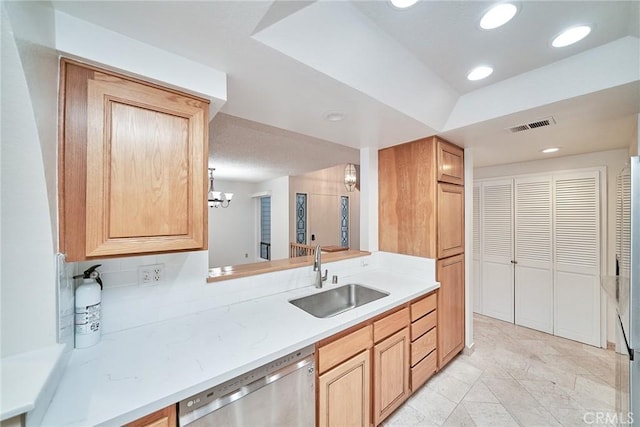 kitchen with visible vents, dishwasher, a sink, light countertops, and a chandelier