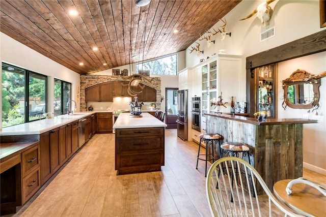 37547 Oak Glen Rd, Oak Glen, CA 92399 - kitchen with visible vents, plenty of natural light, a kitchen island, and wooden ceiling