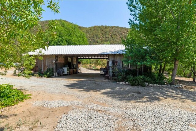 37547 Oak Glen Rd, Oak Glen, CA 92399 - view of parking / parking lot with gravel driveway, an attached carport, and a forest view