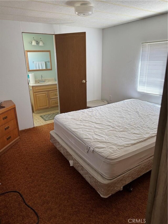 bedroom with ensuite bath and a sink