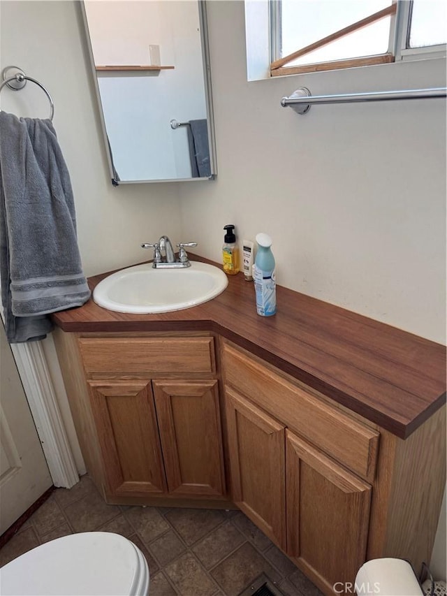 bathroom featuring toilet and vanity